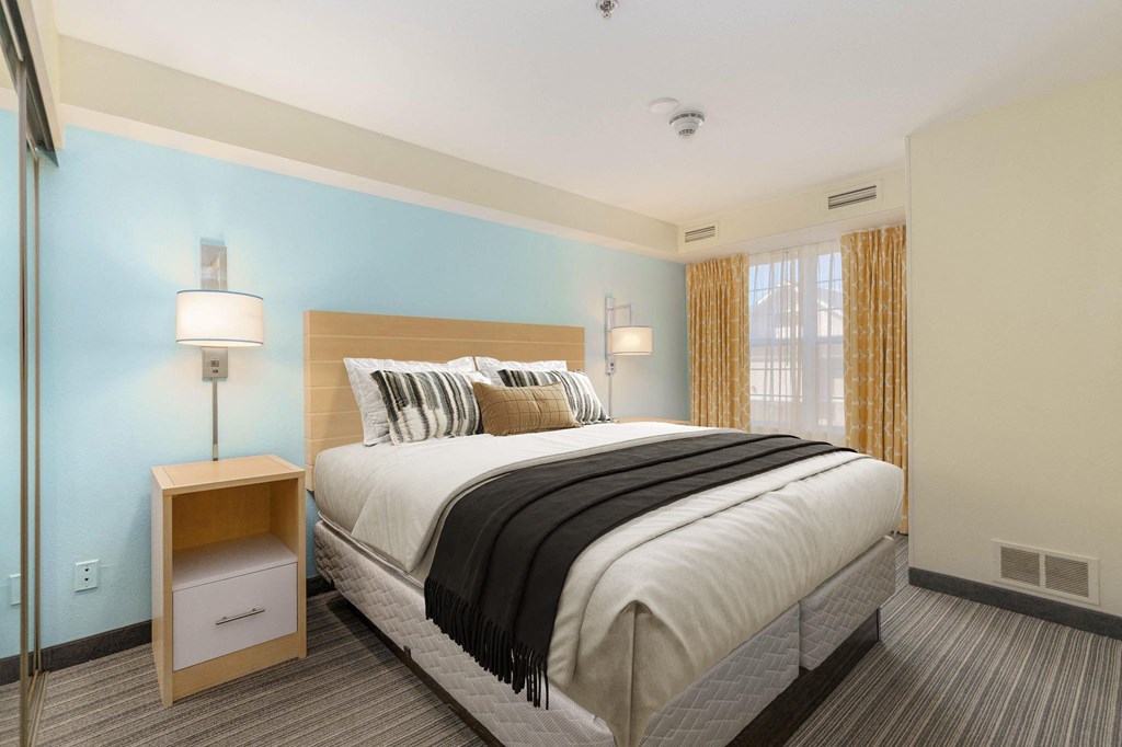 a hotel room with a bed and a window